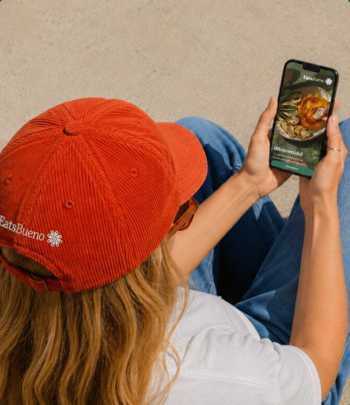 Someone in an eatsbueno cap opening the app