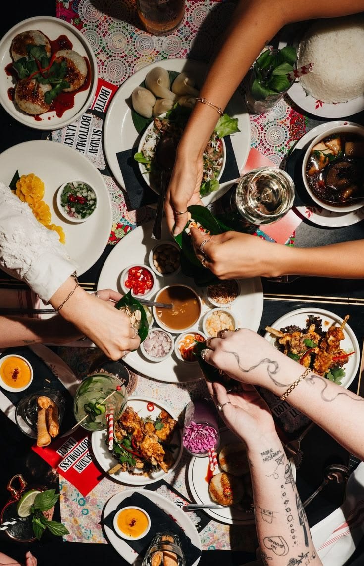 Overhead view of a table shared by many hands