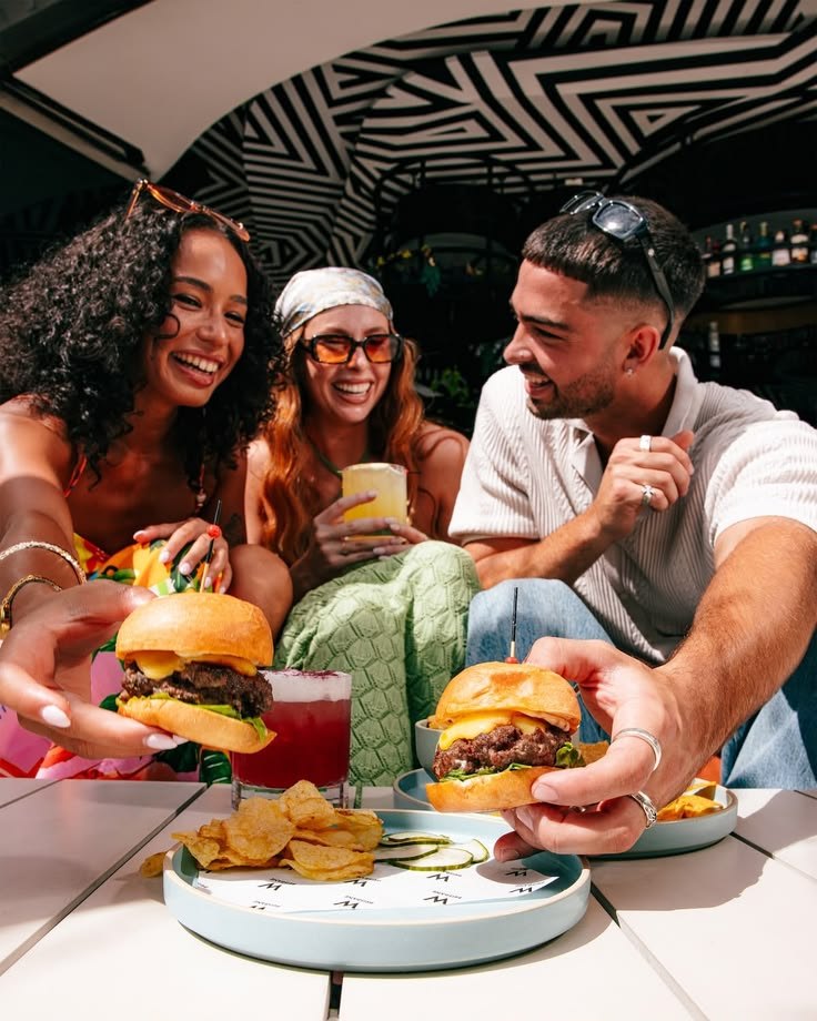 Friends sharing burgers and drinks